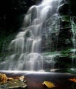 Vertical shot of amazing cascade flowing waterfall. Great for wallpaper