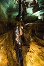 Vertical shot of the amazing cave with illuminated yellow lights