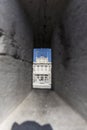 Vertical shot of an ancient building through the hole Royalty Free Stock Photo