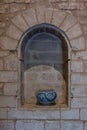 Vertical shot of an ancient ceramic vase in the carved stone arch in Bellver castle, Palma, Spain Royalty Free Stock Photo