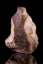 Vertical shot of an ancient stone hand ax, Paleolithic period