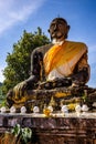 Vertical shot of an ancient and worn statue of Buddha in Wat Phiawat, Xiangkhouang, Laos