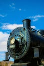 Vertical shot of an antique train under a blue sky