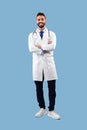 Vertical Shot Of Arabic Male Doctor Standing Over Blue Background Royalty Free Stock Photo