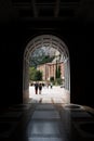 Vertical shot of an arch of a building in Montserrat, Spain, leading to outdoors