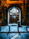 Vertical shot of an arch-shaped old door with street art elements Royalty Free Stock Photo