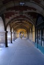 Vertical shot of the arches of the historic Place des Vosges in Paris, France