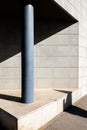 Vertical shot of architecture details of modern concrete wall of a building with a pillar Royalty Free Stock Photo