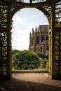 Vertical shot of the Arundel castle and cathedral from a beautiful arch covered in green foliage Royalty Free Stock Photo