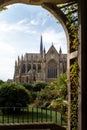 Vertical shot of the Arundel castle and cathedral from a beautiful arch covered in green foliage Royalty Free Stock Photo