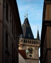 Vertical shot of the Astronomical Clock Tower seen through buildings in Prague Royalty Free Stock Photo