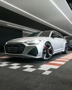 Vertical shot of an Audi RS6 Matte Silver parked in a showroom