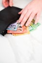 Vertical shot of Australian dollar banknotes in a black wallet on the white background Royalty Free Stock Photo