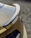 Vertical shot of the back of a Volkswagen Arteon gold color