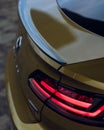 Vertical shot of the back of a Volkswagen Arteon gold color