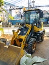Vertical shot of a backhoe loader on the side of the street in Jakarta, Indonesia Royalty Free Stock Photo