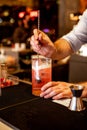 Vertical shot of bartender mixing drinks on a glass in a bar Royalty Free Stock Photo