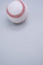 Vertical shot of a baseball ball isolated on light blue background
