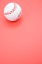 Vertical shot of a baseball ball isolated on pink background