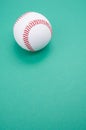 Vertical shot of a baseball ball isolated on turquoise background
