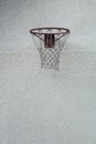 Vertical shot of a basketball hoop on a white concrete wall Royalty Free Stock Photo