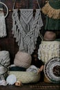 Vertical shot of baskets full of multicolored knitting wool balls and macrame hanging on the wall Royalty Free Stock Photo