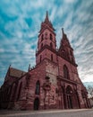 Vertical shot of Basler Muenster Cathedral with cloudy sky in Basel, Switzerland