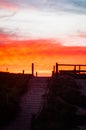 Vertical shot of a beach stairway and the mesmerizing view of the sunset- great for wallpapers