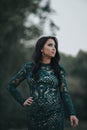 Vertical shot of a beautiful Bosnian Caucasian woman wearing a formal dress, posing outdoors Royalty Free Stock Photo