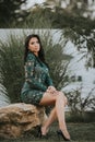 Vertical shot of a beautiful Bosnian Caucasian woman wearing a formal dress, posing outdoors Royalty Free Stock Photo