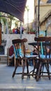 Vertical shot of the beautiful brown antique chairs of an outdoor cafe