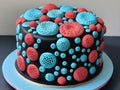 a vertical shot of a beautiful cake covered with a blue chocolate glaze