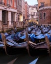 Vertical shot of beautiful gondolas in canal in Venice, Italy