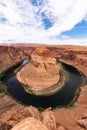 Vertical shot of the beautiful Horseshoe Bend in Arizona under the blue cloudy sky on a sunny day Royalty Free Stock Photo