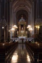Vertical shot of the beautiful interior of a Catholic Church with people sitting on pews Royalty Free Stock Photo