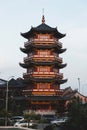 Vertical shot of a beautiful pagoda at the PIK Avenue against the blue sky in Jakarta, Indonesia