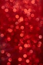 Vertical shot of a beautiful red blurred Christmas background with bokeh effect