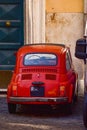 Vertical Shot Of A Beautiful Red Fiat 500 Car On The Streets Of Rome