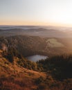 Vertical shot of a beautiful scenery of a small lake in the mountains at sunset