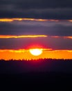 Vertical shot of the beautiful sunset behind the layers of clouds in Oregon Royalty Free Stock Photo