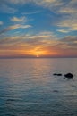 Vertical shot of the beautiful sunset over the calm ocean captured in Lesbos, Greece Royalty Free Stock Photo