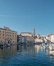 Vertical shot of a beautiful townscape of Piran in Slovenia with a blue skyline and a waterscape