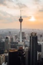 Vertical shot of the beautiful urban skyline of Kuala Lumpur at sunset with the Menara Tower