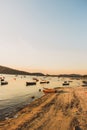 Vertical shot of a beautiful view of fishing boats near coast at sunset Royalty Free Stock Photo