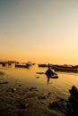 Vertical shot of a beautiful view of fishing boats in the sea near coast at sunset Royalty Free Stock Photo