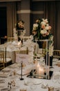 Vertical shot of a beautiful wedding venue table with candles and flowers Royalty Free Stock Photo