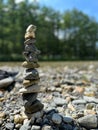 Vertical shot of beautifully balanced rocks on standing other on the blurry background