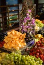 Vertical shot of beautifully designed colorful tropical fruits on a table for an event