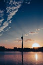 Vertical shot of Beijing central tower silhouette with buildings in the background of a river