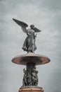 Vertical shot of Bethesda Fountain under a dark cloudy sky in Central Park New York City Royalty Free Stock Photo